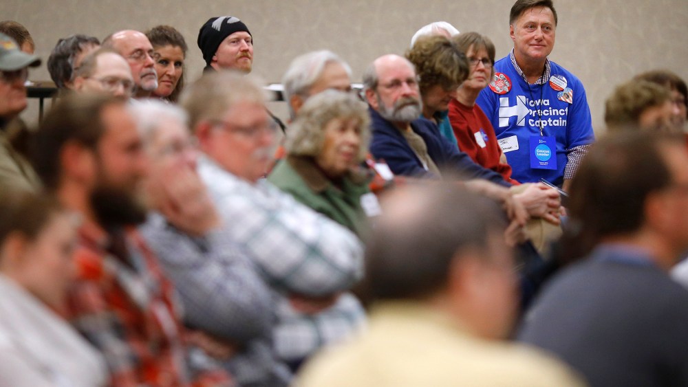 John Grause, top right, precinct captain for Democratic presidential candidate Hillary Clinton, sits with voters during a Democratic party caucus in Nevada, Iowa, Feb. 1, 2016. (Photo by Patrick Semansky/AP)