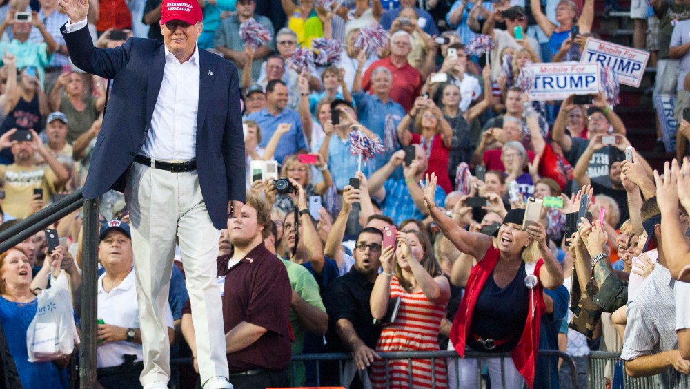 Republican presidential candidate Donald Trump waves to supporters during a campaign rally in Mobile, Ala. on Aug. 21, 2015. (Photo by Brynn Anderson/AP)