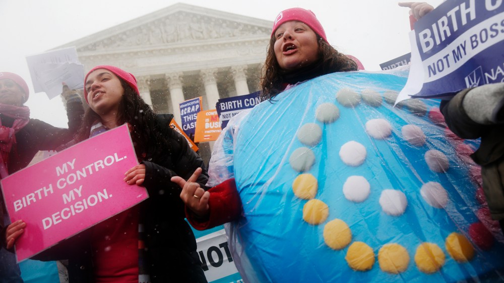Citizens protest in front of the Supreme Court in Washington as the court heard oral arguments challenging a health care law's regulations regarding contraceptives, March 25, 2015. (Photo by Charles Dharapak/AP)