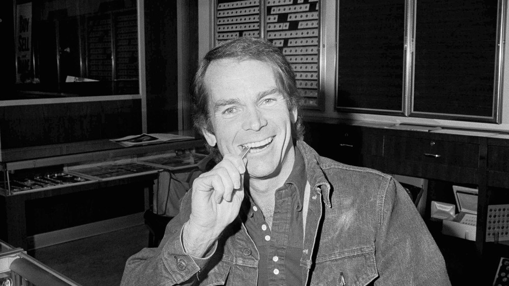 Actor Dean Jones bites a two-ounce bar he bought in Los Angeles, one second after the purchase became legal, Dec. 31, 1974. (Photo by Harold Filan/AP)