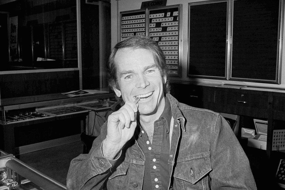 Actor Dean Jones bites a two-ounce bar he bought in Los Angeles, one second after the purchase became legal, Dec. 31, 1974. (Photo by Harold Filan/AP)