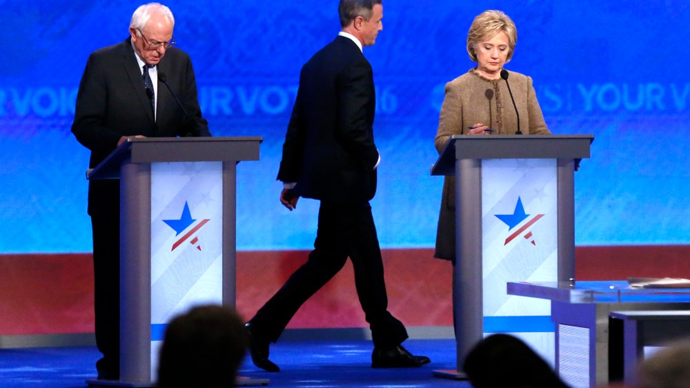 Martin O'Malley, center, returns to the stage past Bernie Sanders, left, and Hillary Clinton after a break during a Democratic presidential primary debate, Dec. 19, 2015, at Saint Anselm College in Manchester, N.H. (Photo by Jim Cole/AP)