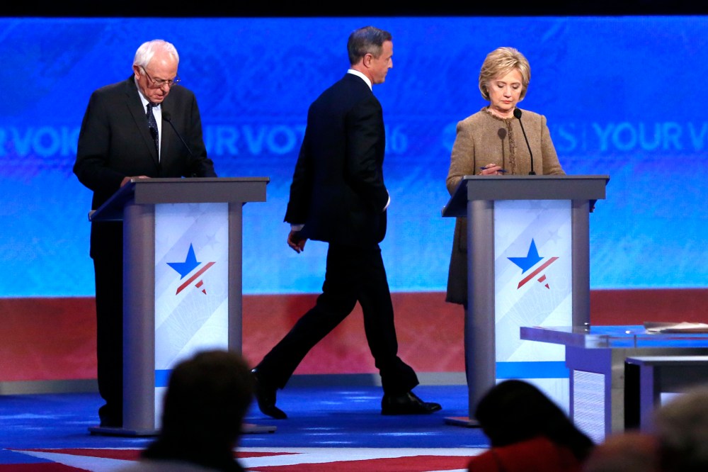 Martin O'Malley, center, returns to the stage past Bernie Sanders, left, and Hillary Clinton after a break during a Democratic presidential primary debate, Dec. 19, 2015, at Saint Anselm College in Manchester, N.H. (Photo by Jim Cole/AP)