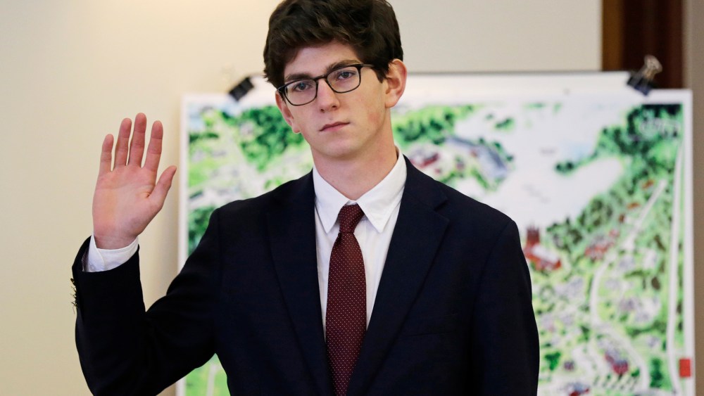 Former St. Paul's School student Owen Labrie raises his hand as he is sworn-in prior to testifying in his trial at Merrimack Superior Court in Concord, N.H., Wednesday, Aug. 26, 2015. (Photo by Charles Krupa/AP)