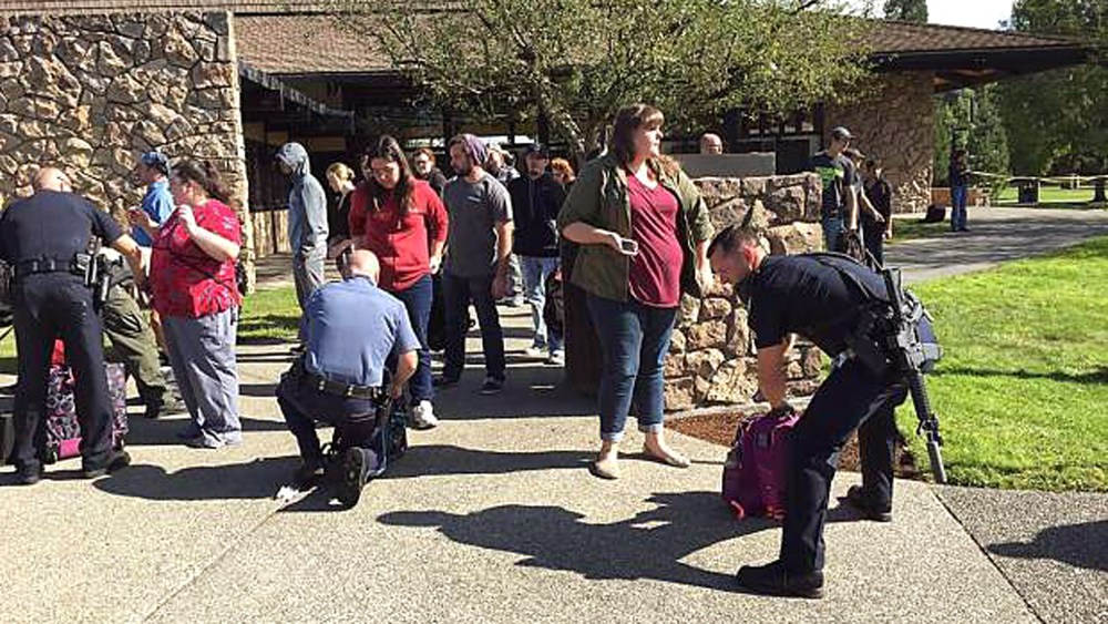Police search students outside Umpqua Community College in Roseburg, Ore., Oct. 1, 2015, following a deadly shooting at the southwestern Oregon community college. (Photo by Mike Sullivan/Roseburg News-Review/AP)