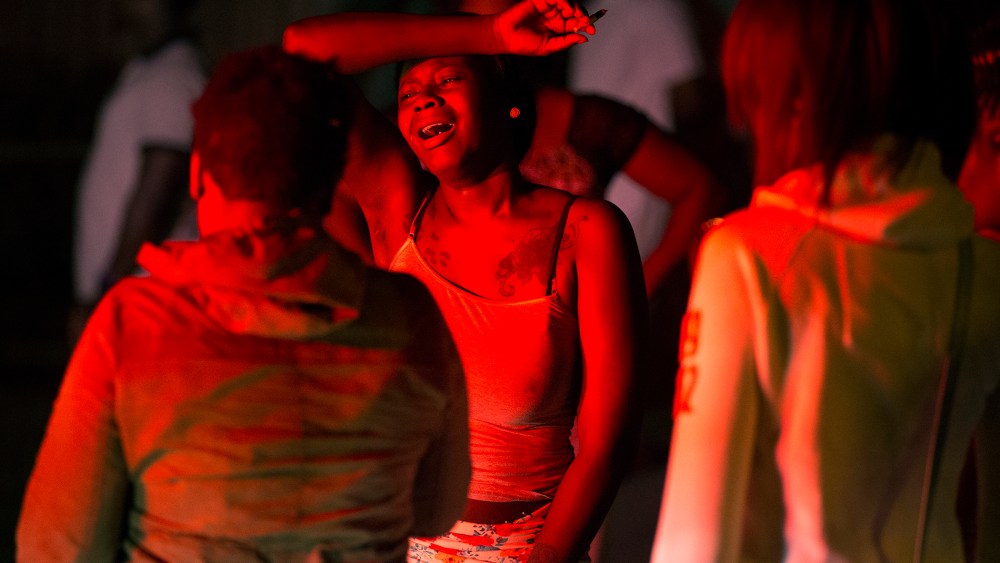 A woman cries at the Boys and Girls Club, early on Aug. 20, 2015, in Rochester, N.Y., where a gunman shot into a crowd gathered outside after a basketball game, fatally wounding several people. (Photo by Lauren Petracca/Democrat & Chronicle/AP)