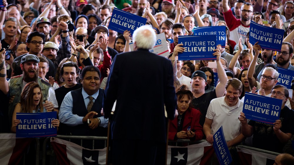 People cheer for Democratic presidential candidate Sen. Bernie Sanders (I-Vt.) as he speaks during a rally at Bonanza High School, Feb. 14, 2016, in Las Vegas. (Photo by Evan Vucci/AP)