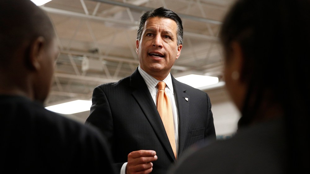 Nevada Governor Brian Sandoval holds a signing ceremony for Senate Bill 432, which allocates millions of dollars for low performing schools, June 3, 2015, in Las Vegas. (Photo by John Locher/AP)