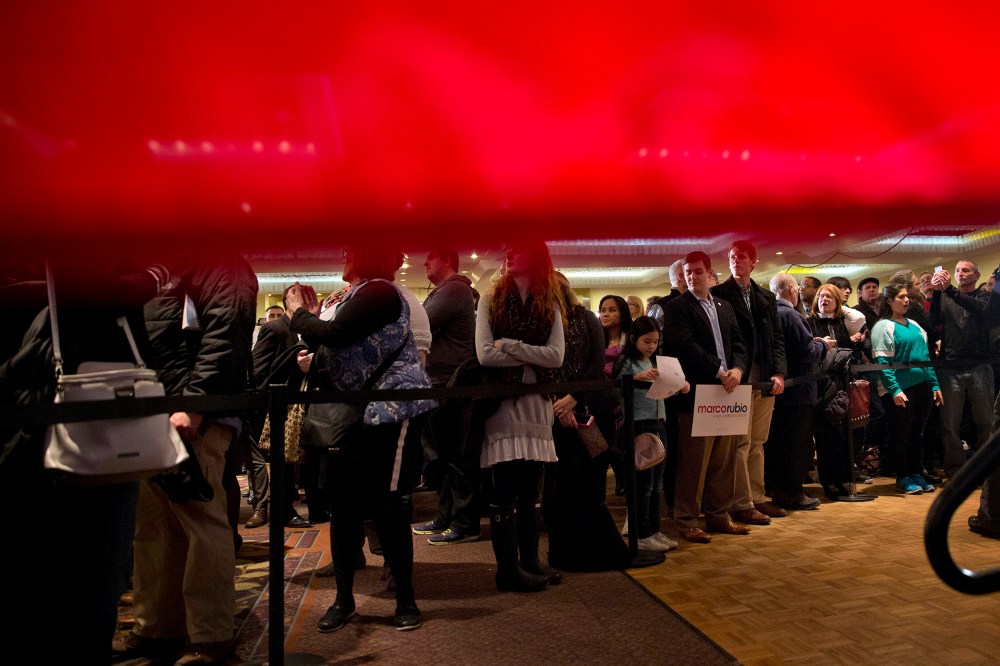 Seen from behind a American flag, supporters of Sen. Marco Rubio, R-Fla. gather for his primary night rally at the Radisson Hotel in Manchester, N.H., Feb. 9, 2016. (Photo by Jacquelyn Martin/AP)