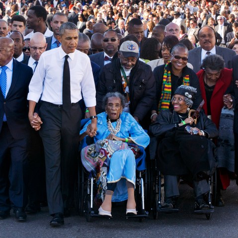 Amelia Boynton Robinson, center, who was beaten during "Bloody Sunday," holds President Barack Obama's hand as they walk across the Edmund Pettus Bridge in Selma, Ala., Saturday, March 7, 2015. (Photo by Jacquelyn Martin/AP)