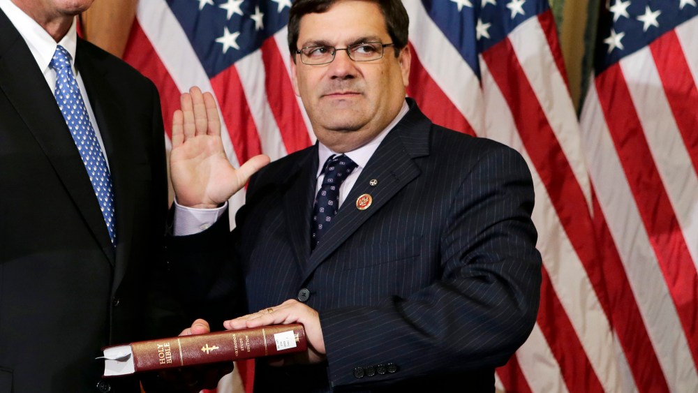 Rep. Gus M. Bilirakis, R-Fla., stands for a ceremonial photo in the Rayburn Room of the Capitol after the new 113th Congress convened on Jan. 3, 2013, in Washington. (Photo by J. Scott Applewhite/AP)