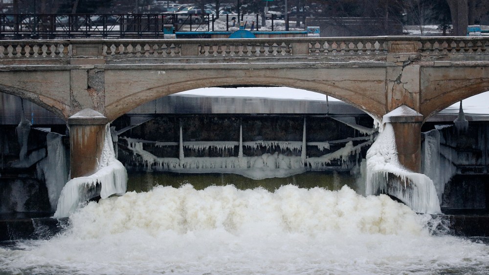 Water from the Flint River flows through the Hamilton Dam near downtown Flint, Mich., on Jan. 21, 2016. (Photo by Paul Sancya/AP)