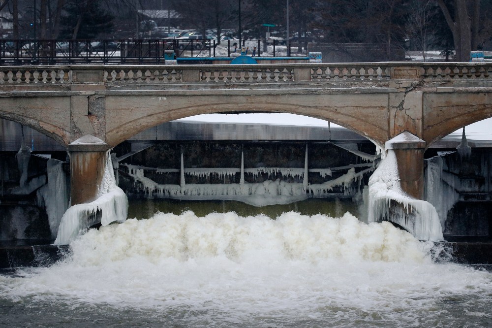 Water from the Flint River flows through the Hamilton Dam near downtown Flint, Mich., on Jan. 21, 2016. (Photo by Paul Sancya/AP)
