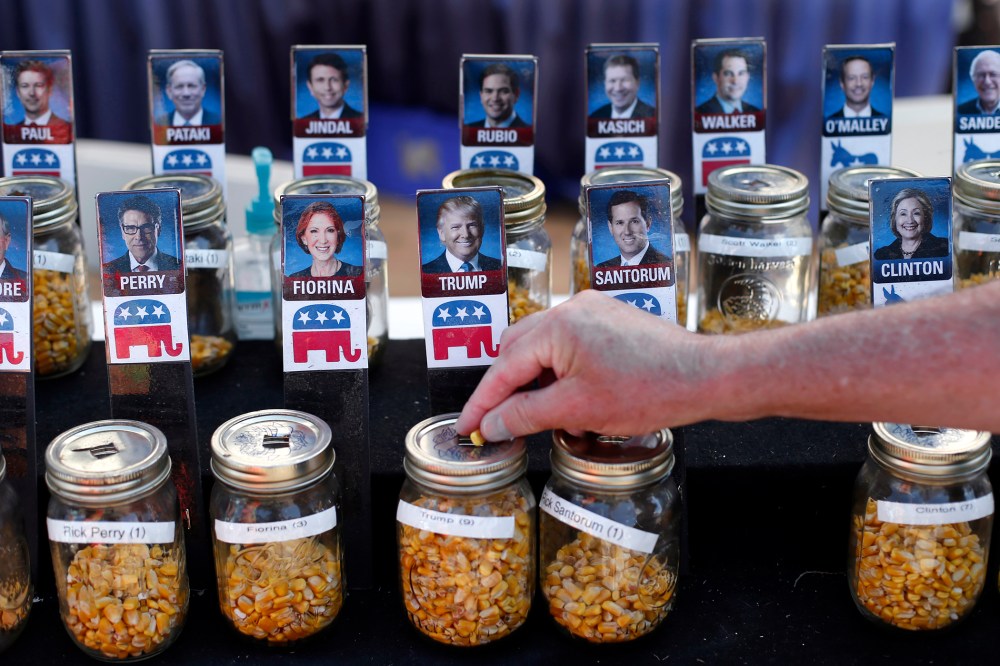 A visitor casts their vote with a kernel of corn for presidential candidate Donald Trump in a straw poll at the Iowa State Fair, Aug. 20, 2015, in Des Moines, Iowa. (Photo by Paul Sancya/AP)