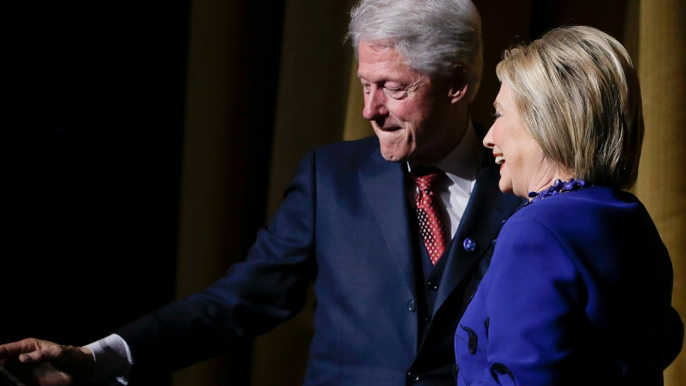 Former President Bill Clinton makes way for Democratic presidential candidate Hillary Clinton during the "Hillary Victory Fund: I'm with Her" benefit concert, March 2, 2016, in New York. (Photo by Julie Jacobson/AP)