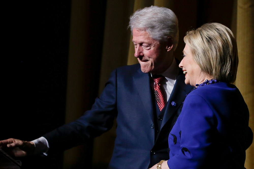 Former President Bill Clinton makes way for Democratic presidential candidate Hillary Clinton during the "Hillary Victory Fund: I'm with Her" benefit concert, March 2, 2016, in New York. (Photo by Julie Jacobson/AP)
