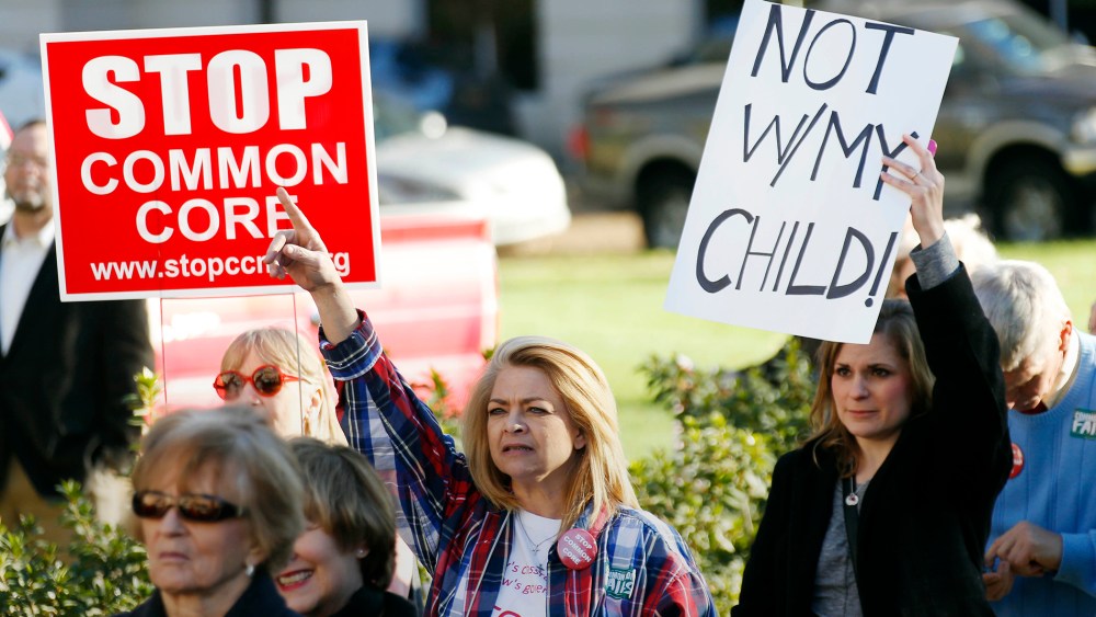 Common Core opponents wave signs and cheer at a rally opposing Mississippi's continued use of the Common Core academic standards on the steps of the Capitol in Jackson, Miss., Jan. 6, 2015. (Photo by Rogelio V. Solis/AP)