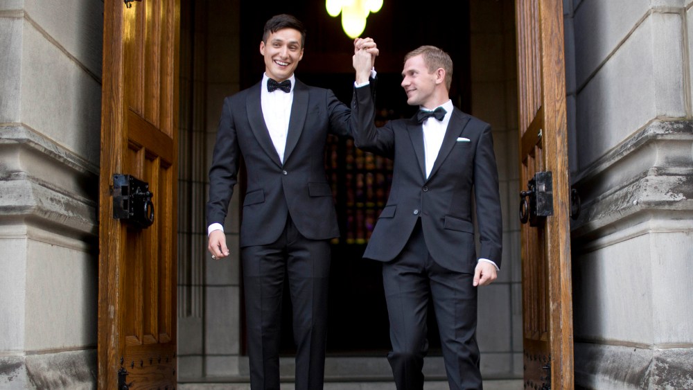 West Point graduate Larry Lennox-Choate, left, and Daniel Lennox-Choate, leave church following their wedding ceremony on Nov. 2, 2013, at the U.S. Military Academy's Cadet Chapel in West Point, N.Y. (Photo by Jill Knight/AP)
