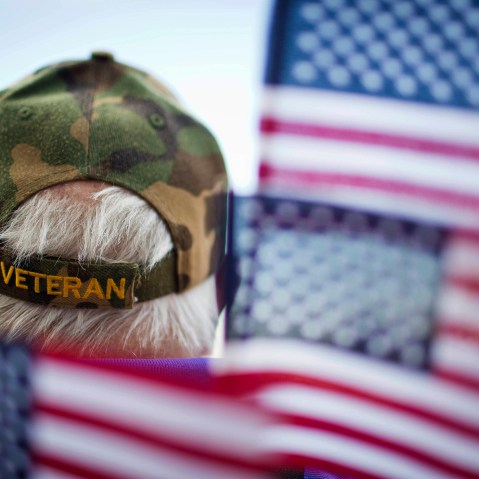 A veterans is surrounded by flags at a Veterans Day parade in Montgomery, Ala. (Photo by Brynn Anderson/AP)