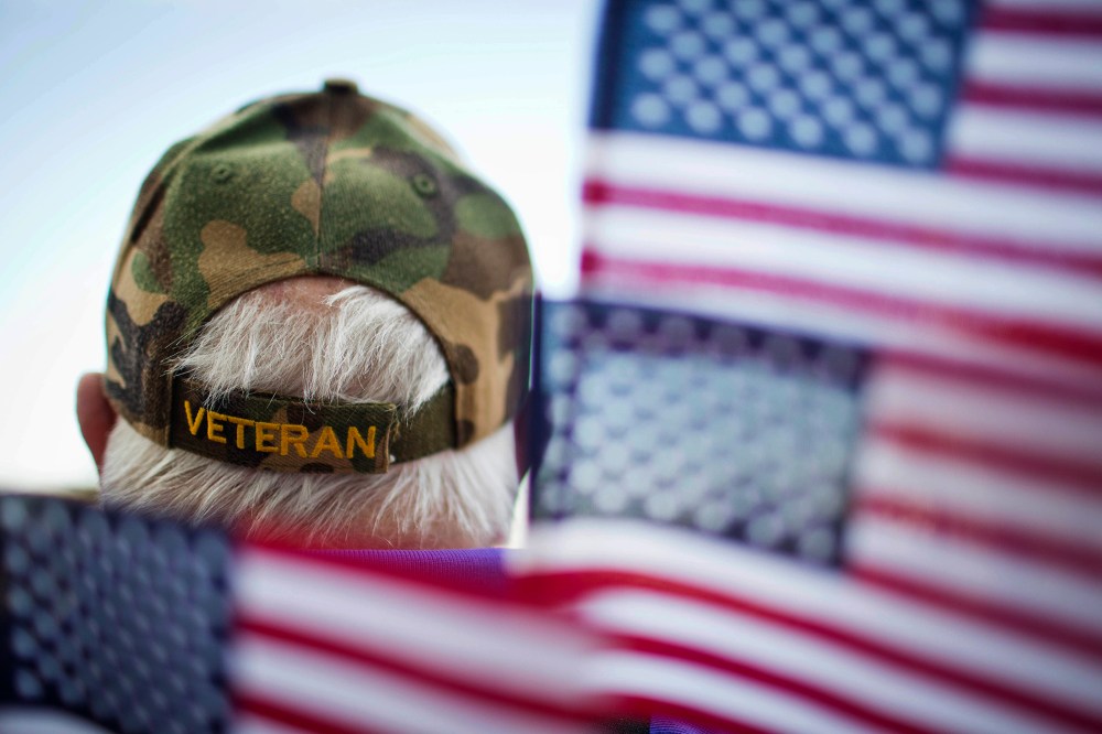 A veterans is surrounded by flags at a Veterans Day parade in Montgomery, Ala. (Photo by Brynn Anderson/AP)