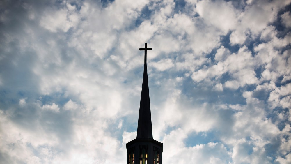 The sun rises behind the steeple of a church, Aug. 23, 2015, in Plains, Ga. (Photo by David Goldman/AP)