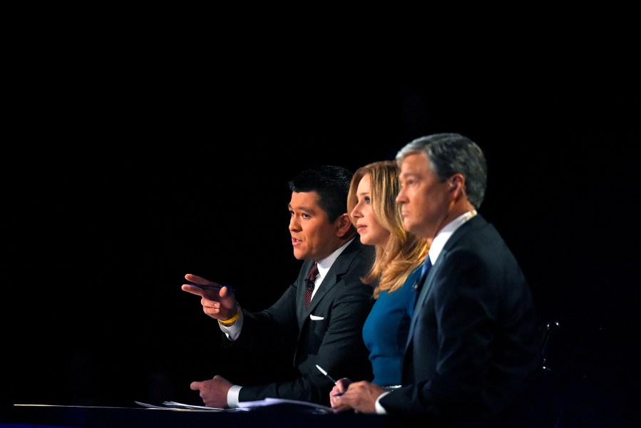 Debate moderators (from left) Carl Quintanilla, Becky Quick and John Harwood appear during the CNBC Republican presidential debate at the University of Colorado, Oct. 28, 2015, in Boulder, Colo. (Photo by Mark J. Terrill/AP)