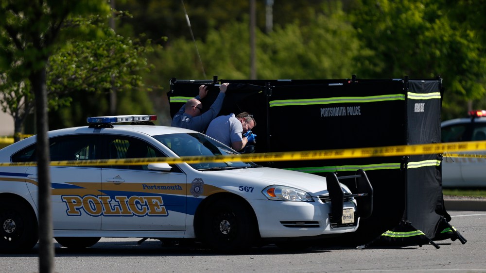 Authorities collect evidence and investigate a police involved shooting in a Wal-Mart parking lot on Wednesday, April 22, 2015 in Portsmouth, Va. (Photo by Stephen M. Katz/The Virginian-Pilot/AP)