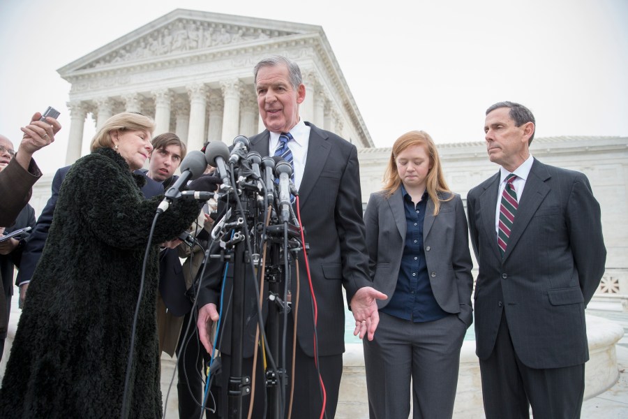 Abigail Fisher, second from right, who challenged the use of race in college admissions, listens as her lawyer Bert Rein, center, speaks with reporters outside the Supreme Court in Washington, Dec. 9, 2015. (Photo by J. Scott Applewhite/AP)