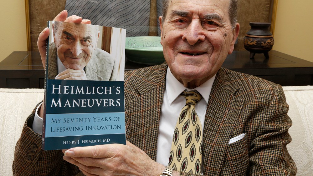In this Wednesday, Feb. 5, 2014 photo, Dr. Henry Heimlich holds his memoirs prior to being interviewed at his home in Cincinnati. (Photo by Al Behrman/AP)