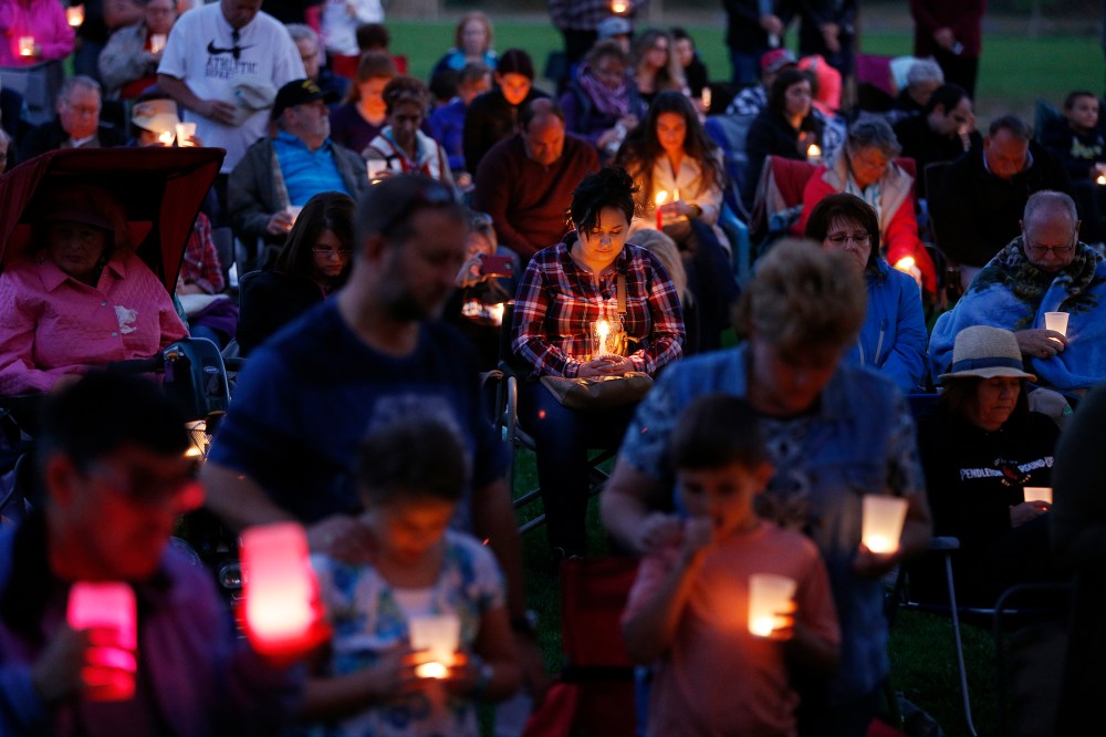 People bow their heads in prayer during a vigil held in honor of the victims of the fatal shooting at Umpqua Community College, Oct. 3, 2015, in Winston, Ore. (Photo by John Locher/AP)