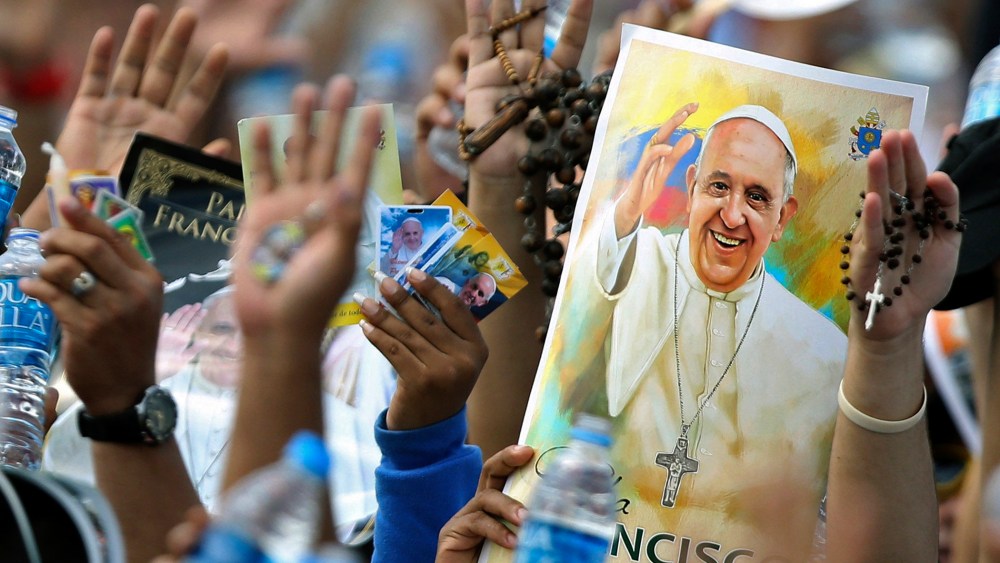 Pilgrims hold up their hands to be blessed by Pope Francis during a Mass at the Samanes Park in Guayaquil, Ecuador on July 6, 2015. (Photo by Fernando Vergara/AP)
