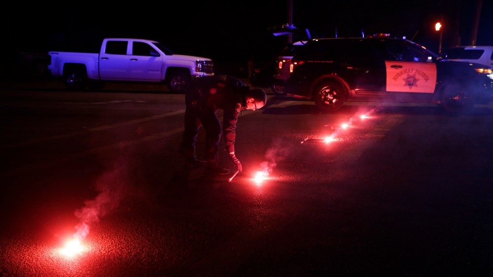 A police officer lights up flares near the scene where a shootout took place, Dec. 2, 2015, in San Bernardino, Calif. (Photo by Jae C. Hong/AP)