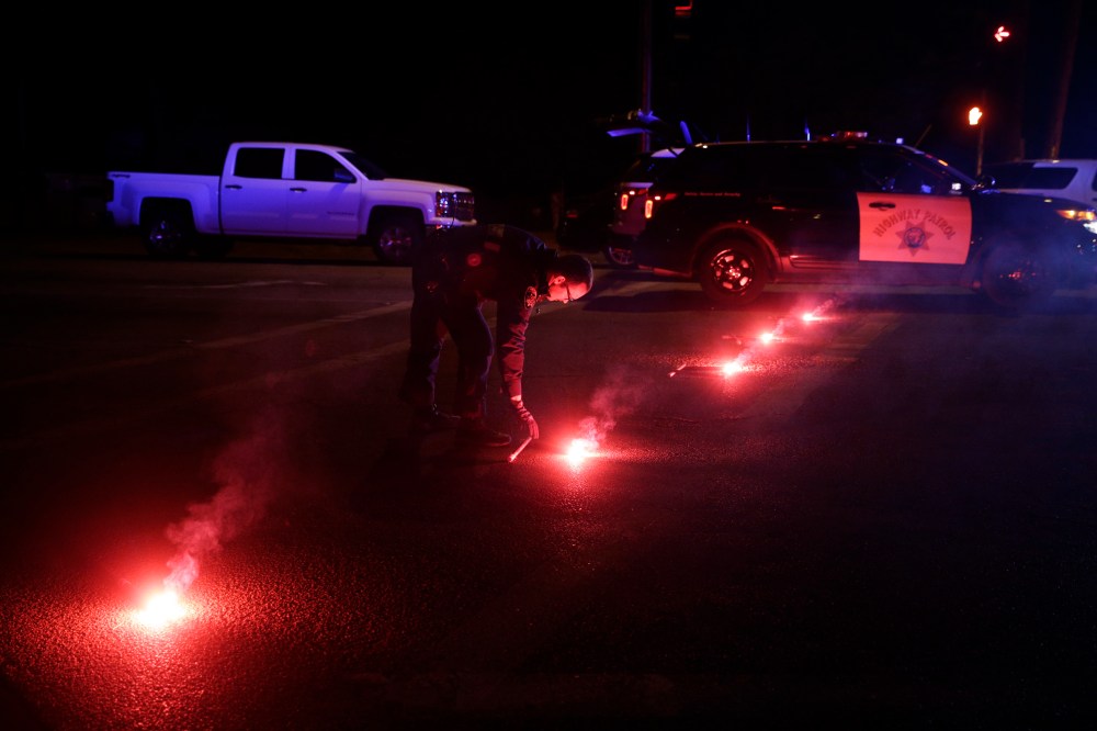 A police officer lights up flares near the scene where a shootout took place, Dec. 2, 2015, in San Bernardino, Calif. (Photo by Jae C. Hong/AP)
