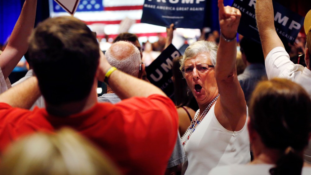 A woman turn around and gestures to the news media as former Alaska Gov. Sarah Palin talks about the news media at Donald Trump's campaign event in Tampa, Fla., March 14, 2016. (Photo by Gerald Herbert/AP)