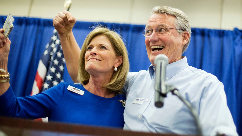 Georgia Republican U.S. Congressman Rick Allen, cheers with wife Bettie at a campaign event for Georgia Republican U.S. Senate candidate David Perdue, Wednesday, Oct. 29, 2014, in Augusta, Ga.