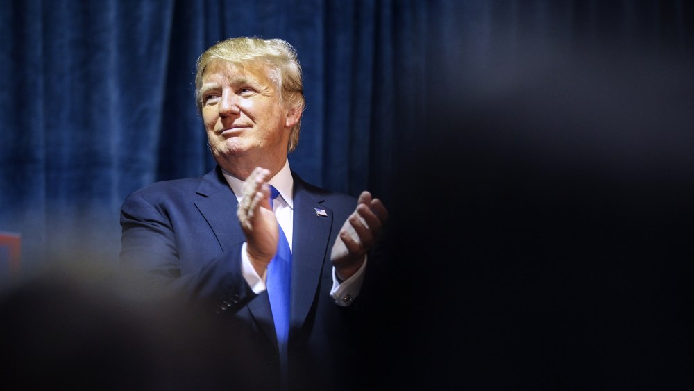 Republican presidential candidate Donald Trump claps as he listens during an event in Manchester, N.H., Nov. 11, 2015. (Photo by Cheryl Senter/AP)