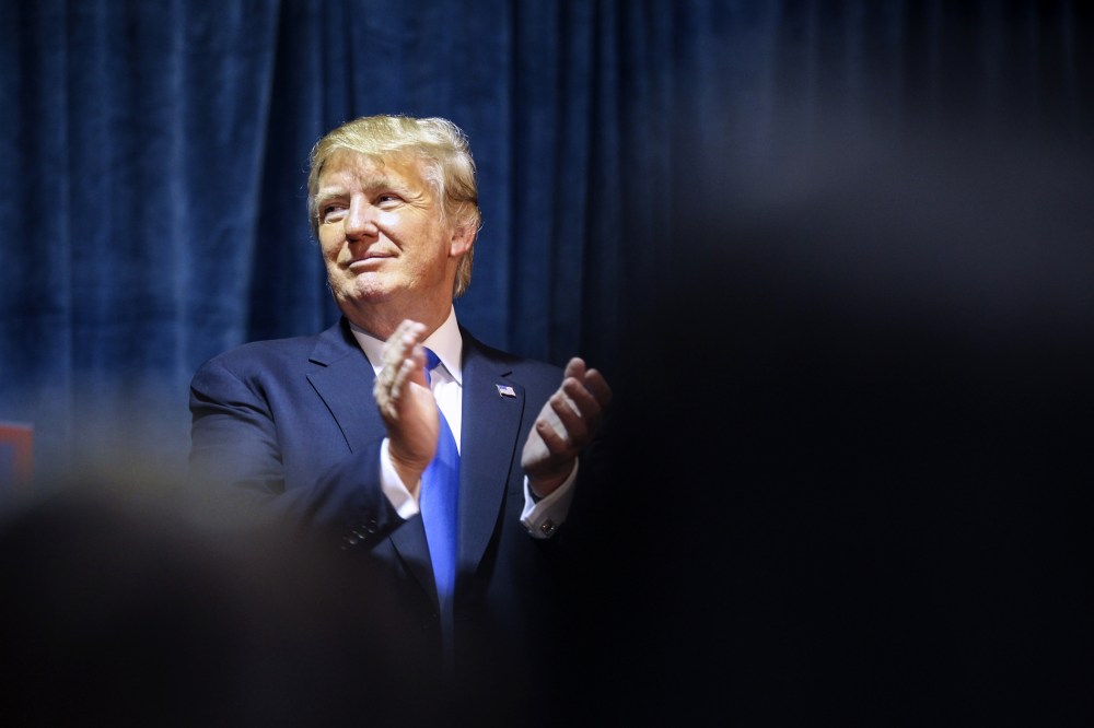 Republican presidential candidate Donald Trump claps as he listens during an event in Manchester, N.H., Nov. 11, 2015. (Photo by Cheryl Senter/AP)
