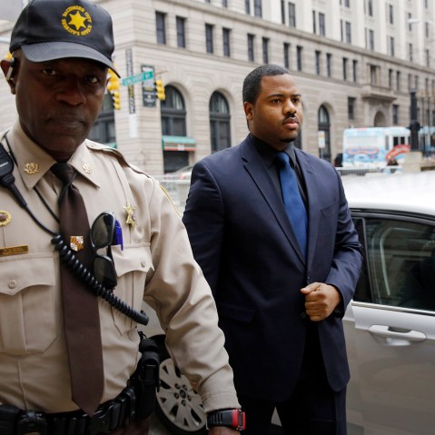 Officer William Porter, right, one of six Baltimore city police officers charged in connection to the death of Freddie Gray, walks into the courthouse, Dec. 16, 2015, in Baltimore. (Photo by Patrick Semansky/AP)