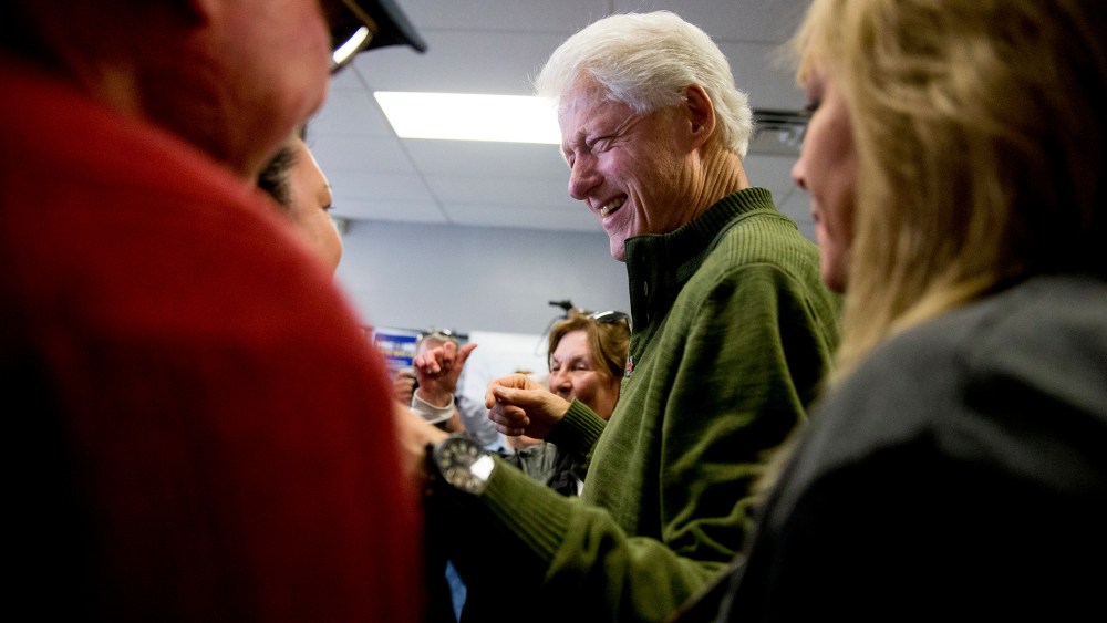 Former President Bill Clinton greets supporters at a campaign office for Democratic presidential candidate Hillary Clinton in Ankeny, Iowa, Feb. 1, 2016. (Photo by Andrew Harnik/AP)