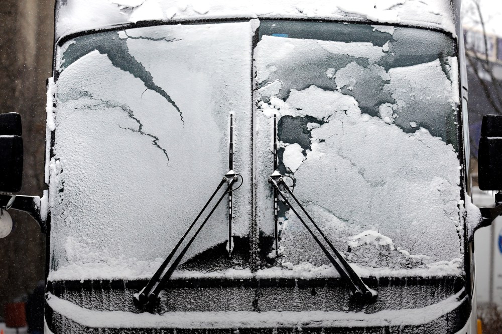 A bus window is covered by snow and ice, Feb. 14, 2016, in Evanston, Ill. (Photo by Nam Y. Huh/AP)