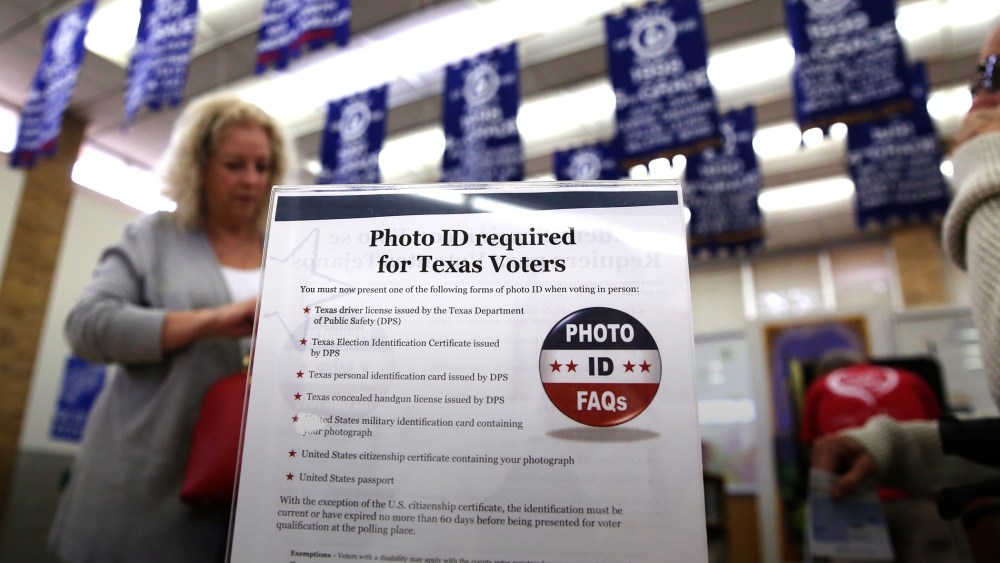 A sign tells voters of voter ID requirements before participating in the primary election at Sherrod Elementary school in Arlington, Texas, March 1, 2016. (Photo by LM Otero/AP)