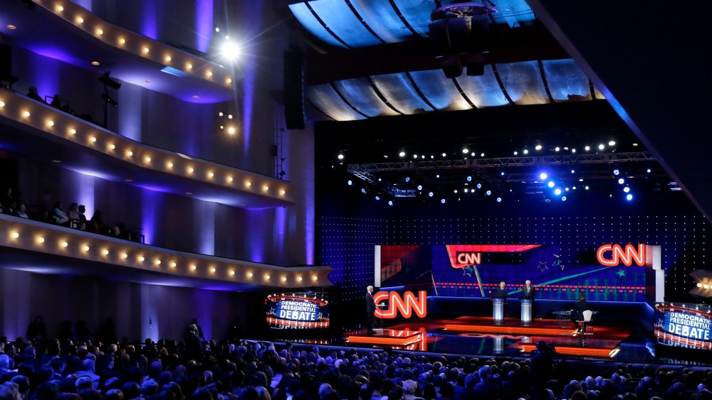 Democratic presidential candidates Hillary Clinton, left, and, Sen. Bernie Sanders listen to a question during a Democratic presidential primary debate at the University of Michigan-Flint on March 6, 2016, in Flint, Mich. (Photo by Carlos Osorio/AP)