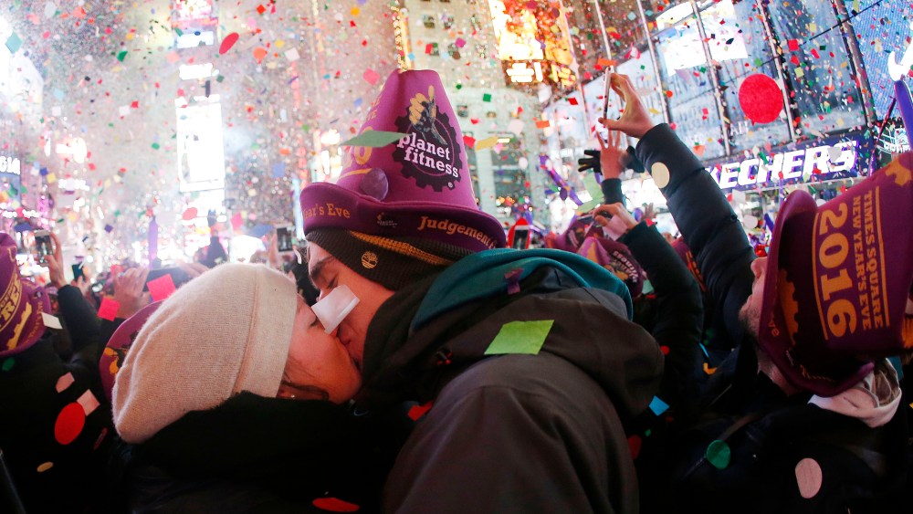 A couple kisses while ringing in the new year at Times Square, Jan. 1, 2016, in New York. (Photo by Julio Cortez/AP)