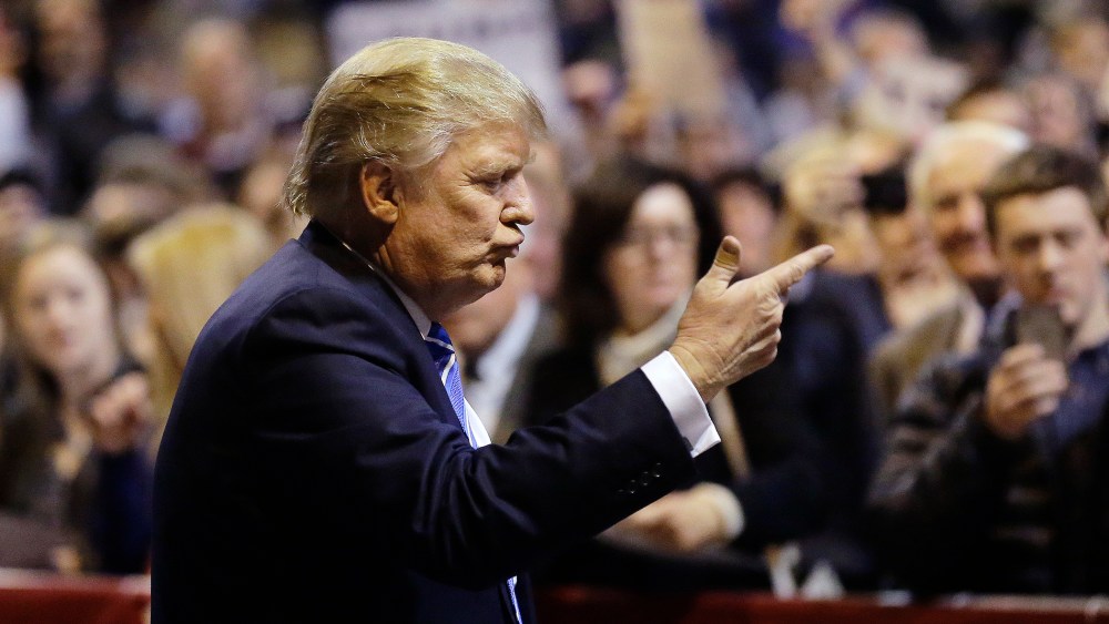 Republican presidential candidate Donald Trump gestures toward the audience before signing autographs at the conclusion of a campaign event, Nov. 18, 2015, in Worcester, Mass. (Photo by Steven Senne/AP)