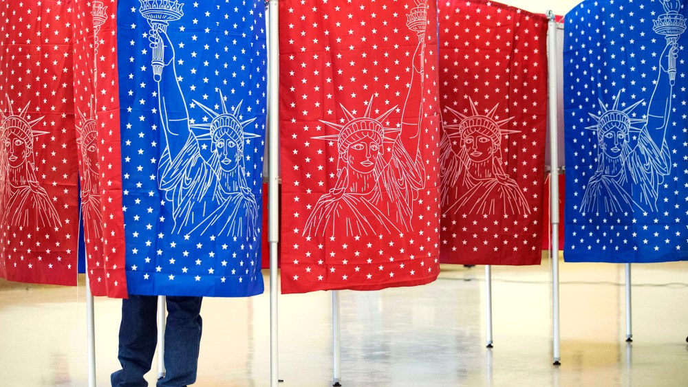 A voter marks a ballot for the New Hampshire primary inside a voting booth at a polling place, Feb. 9, 2016, in Manchester, N.H. (Photo by David Goldman/AP)