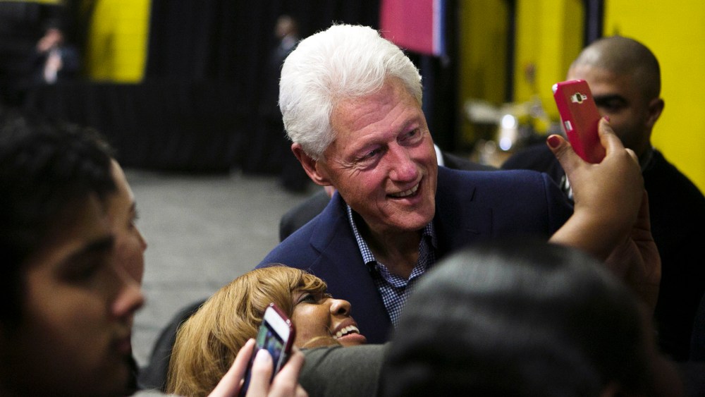 Former President Bill Clinton smiles for a selfie with a supporter of his wife following a speech at Whitehaven High School, Feb. 11, 2016, in Memphis, Tenn. (Photo by Yalonda M. James/The Commercial Appeal/AP)