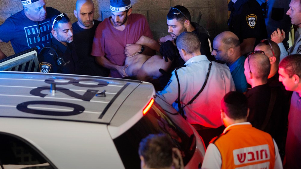 Israeli police arrest a Palestinian identified as Raed Khalil bin Mahmoud, a 36-year-old from the West Bank village of Dura in Tel Aviv, Israel, Nov. 19, 2015. (Photo by Moti Milrod/AP)