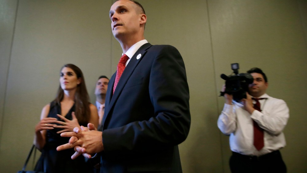 In this photo taken Aug. 25, 2015, Republican presidential candidate Donald Trump's campaign manager Corey Lewandowski watches as Trump speaks in Dubuque, Iowa. (Photo by Charlie Neibergall/AP)