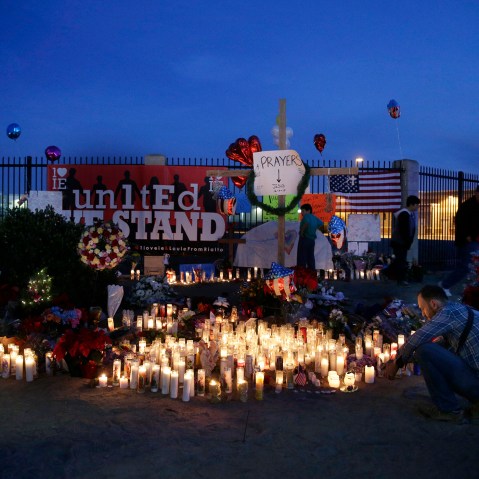 People pay respects at a makeshift memorial honoring the victims of Wednesday's shooting rampage, Dec. 5, 2015, in San Bernardino, Calif. (Photo by Jae C. Hong/AP)