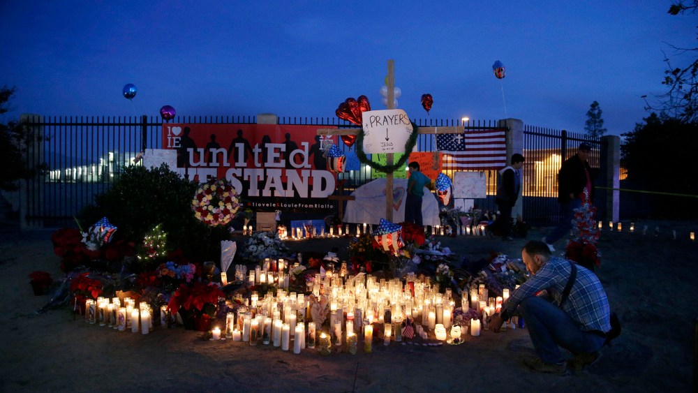 People pay respects at a makeshift memorial honoring the victims of Wednesday's shooting rampage, Dec. 5, 2015, in San Bernardino, Calif. (Photo by Jae C. Hong/AP)